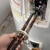 Technician diagnosing a hybrid water heater fault in a Lancaster, PA basement
